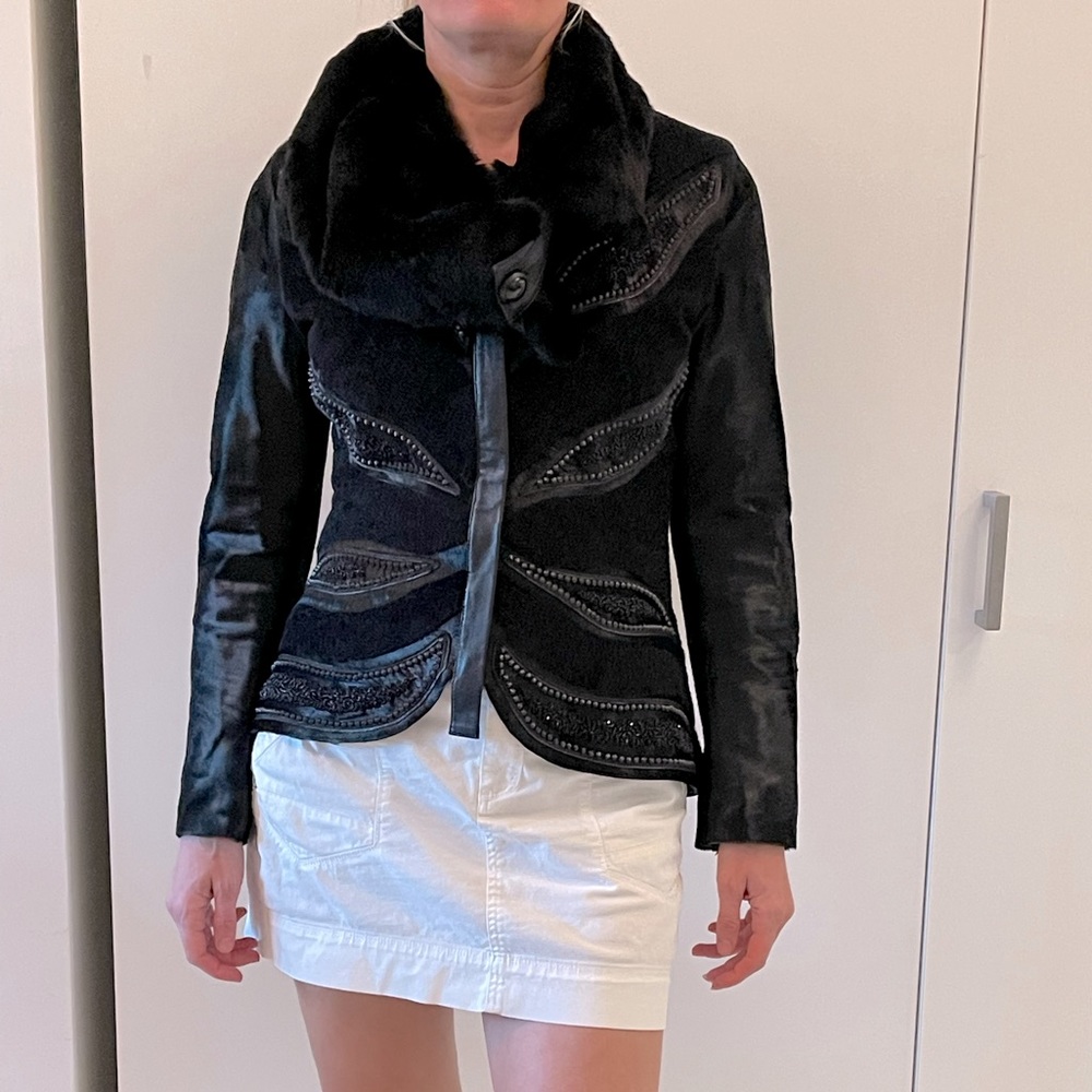 Calf leather with metal embellishment and needed jacket.